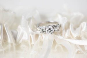 engagement ring on white garter belt