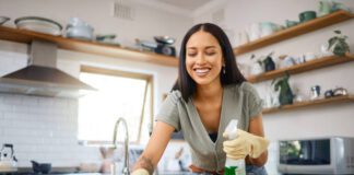 Tips For Keeping Your Kitchen Smelling Fresh: Easy Hacks to Banish Odors lady cleaning to keep her kitchen smelling fresh